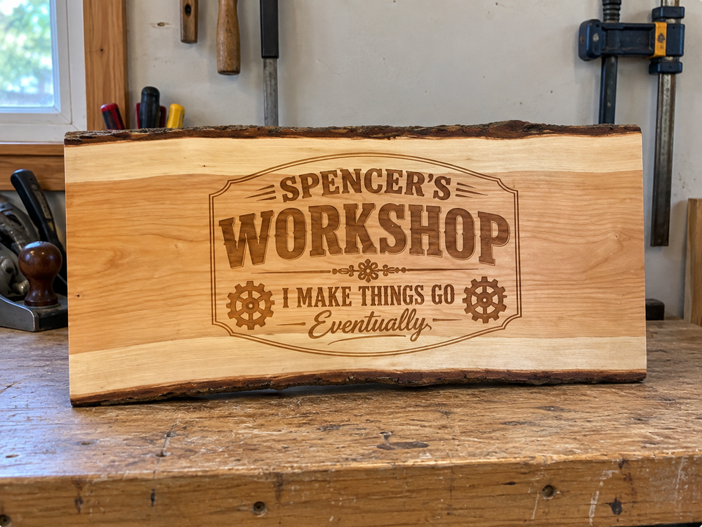 Spencer’s Workshop personalized live edge sign displayed on a workshop bench