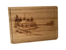 Christmas Cabin bamboo serving board on white background, alternate angle.