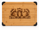 Christmas horses engraved bamboo serving board with Santa hats, snowy fence, juice groove and black corner grips.