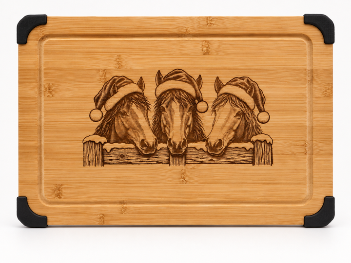 Christmas horses engraved bamboo serving board with Santa hats, snowy fence, juice groove and black corner grips.