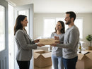 Real estate agent handing over keys to a couple in a new home