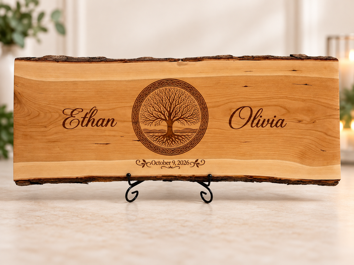 Personalized live-edge wedding board with Tree of Life engraving and custom names, shown on a display stand.