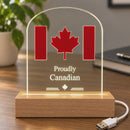 Proudly Canadian clear acrylic LED display glowing warm white on a work desk