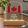 Proudly Canadian clear acrylic LED display glowing warm white on a work desk