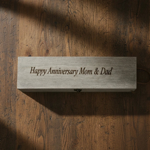 Wooden block with 'Happy Anniversary Mom & Dad' text on a wooden surface